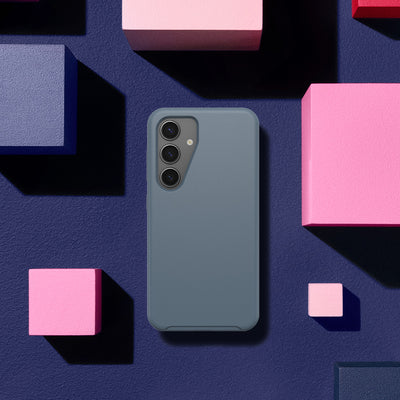 Blue phone case on a dark blue background with pink geometric shapes