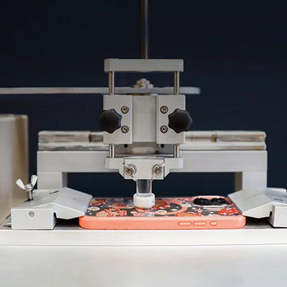 Phone case being tested on by a scratch machine
